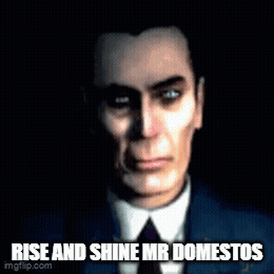 A Man In A Suit And Tie With The Words Rise And Shine Mr Domestos Written Below Him . GIF