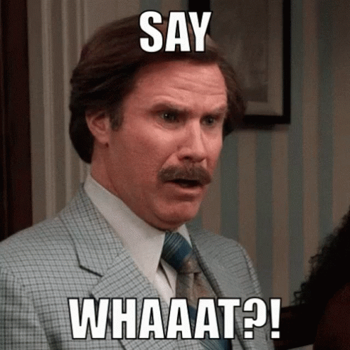 A Man In A Suit And Tie With The Words Say Whaaat On His Face GIF