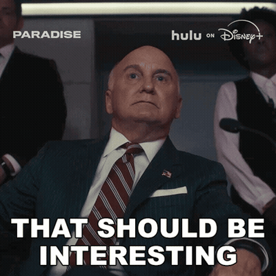 A Man In A Suit And Tie With The Words That Should Be Interesting Below Him GIF