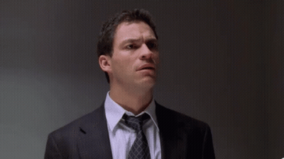A Man In A Suit And Tie With The Words " The Fuck Did I Do " Behind Him GIF