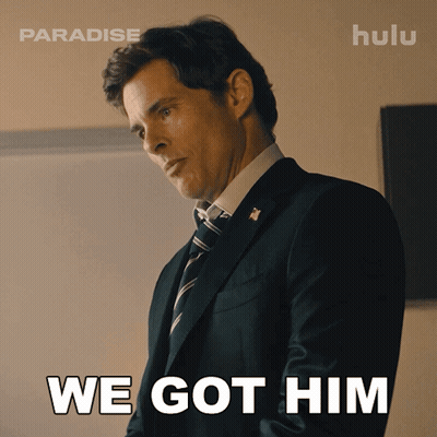 A Man In A Suit And Tie With The Words We Got Him Behind Him GIF