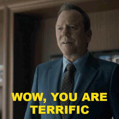 A Man In A Suit And Tie With The Words Wow You Are Terrific Behind Him GIF