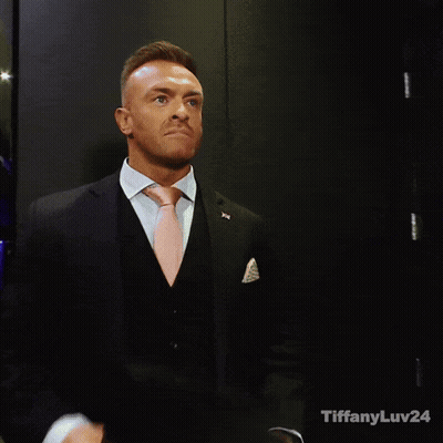 A Man In A Suit And Tie With Tiffanyluv24 Written On The Bottom Right GIF