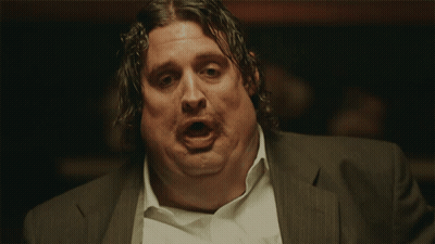A Man In A Suit And White Shirt Has His Mouth Open GIF