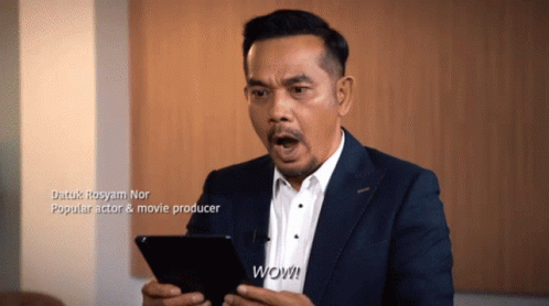 A Man In A Suit And White Shirt Holds A Tablet And Says Wow GIF