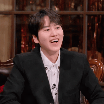 A Man In A Suit And White Shirt Is Laughing GIF