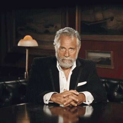 A Man In A Suit And White Shirt Is Laughing GIF