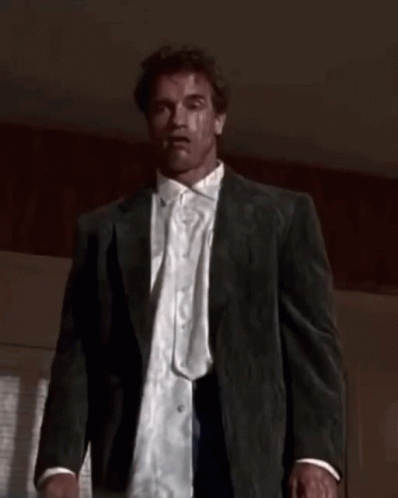 A Man In A Suit And White Shirt Is Looking At The Camera GIF