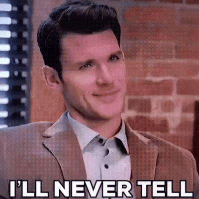 A Man In A Suit And White Shirt Is Smiling And Saying `` I 'Ll Never Tell '' . GIF