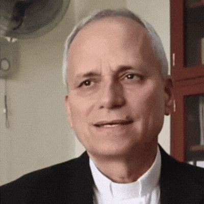 A Man In A Suit And White Shirt Is Smiling GIF
