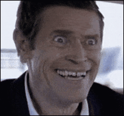 A Man In A Suit And White Shirt Is Smiling With His Mouth Open . GIF