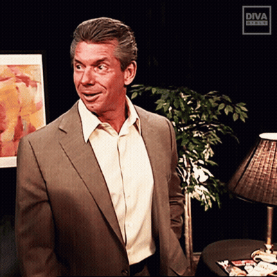 A Man In A Suit And White Shirt Is Standing In Front Of A Diva Studio Logo GIF