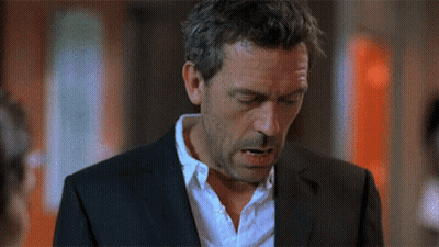 A Man In A Suit And White Shirt Looks Down With His Eyes Closed GIF