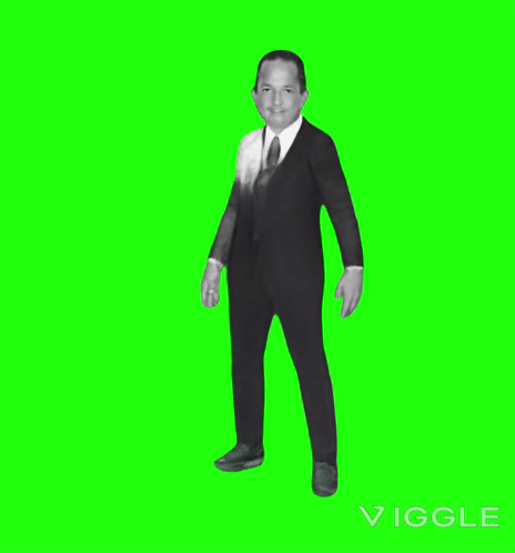 A Man In A Suit Dancing On A Green Screen GIF