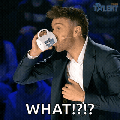 A Man In A Suit Drinking From A Mug With The Words What Written On The Bottom GIF