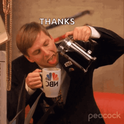 A Man In A Suit Drinking From A Nbc Mug GIF