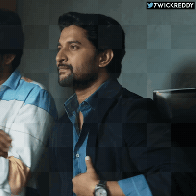 A Man In A Suit Giving A Thumbs Up Next To A Twitter Logo That Says 7Wickreddy GIF