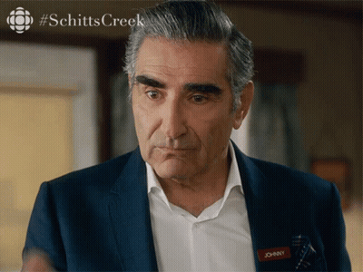 A Man In A Suit Has A Name Tag That Says Johnny On It GIF