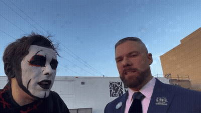 A Man In A Suit Has A Pin On His Jacket That Says ' J.s. ' On It GIF