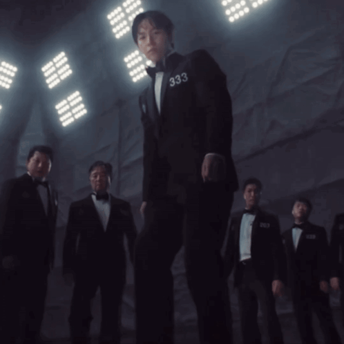 A Man In A Suit Has The Number 333 On His Sleeve GIF