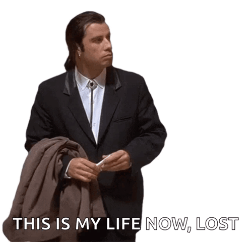 A Man In A Suit Holding A Jacket And A Cigarette With The Words This Is My Life Now Lost Below Him GIF