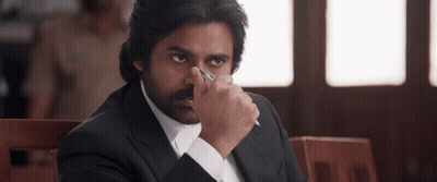 A Man In A Suit Holds A Pen In His Hand GIF