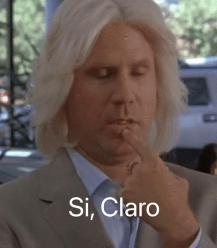 A Man In A Suit Holds His Finger To His Mouth And Says Si Claro In White Letters GIF