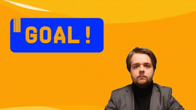 A Man In A Suit Holds His Fist Up In Front Of A Blue Sign That Says Goal GIF