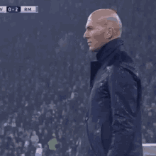 A Man In A Suit Holds His Hand To His Head GIF