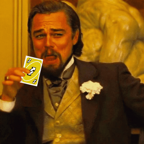 A Man In A Suit Holds Up A Card That Says ' U ' On It GIF