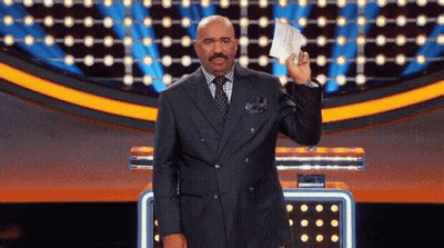 A Man In A Suit Holds Up A Piece Of Paper GIF