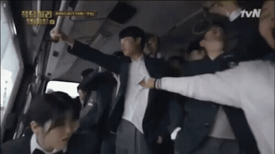 A Man In A Suit Is Being Held Up By A Group Of People In A Bus . GIF