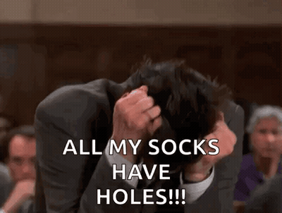 A Man In A Suit Is Covering His Face With His Hands And Saying `` All My Socks Have Holes ! '' GIF