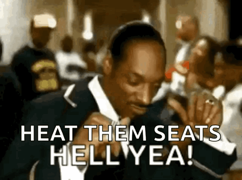 A Man In A Suit Is Dancing And Says Heat Them Seats Hell Yea GIF