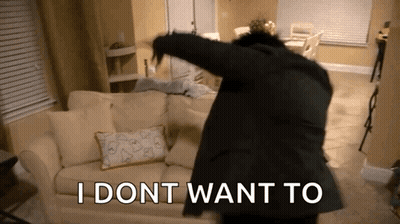 A Man In A Suit Is Dancing In A Living Room With The Words I Dont Want To Written On The Floor GIF