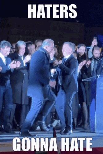 A Man In A Suit Is Dancing In Front Of A Crowd With A Caption That Says Haters Gonna Hate GIF