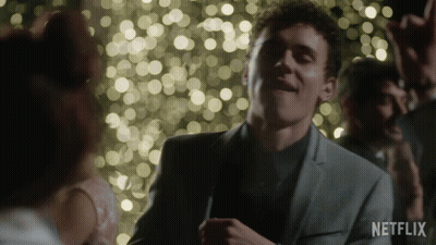 A Man In A Suit Is Dancing In Front Of A Crowd With A Netflix Logo In The Corner GIF