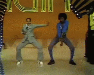 A Man In A Suit Is Dancing In Front Of A Sign That Says ' I Love You ' GIF