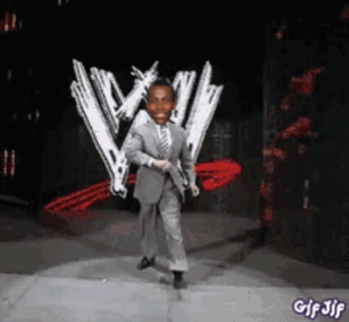A Man In A Suit Is Dancing In Front Of A W Logo GIF