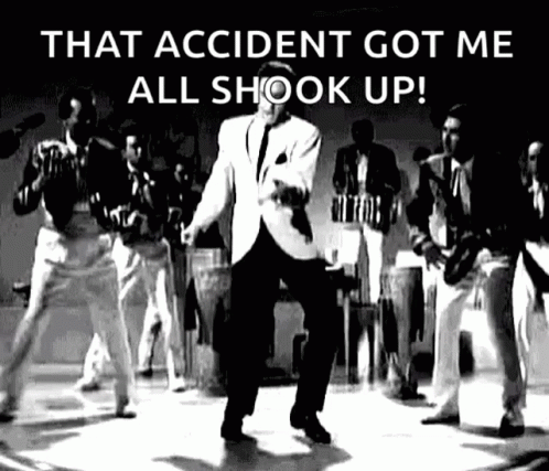 A Man In A Suit Is Dancing On A Stage In Front Of A Group Of Men . GIF