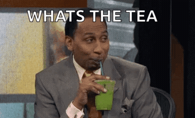 A Man In A Suit Is Drinking A Green Smoothie With A Straw . GIF