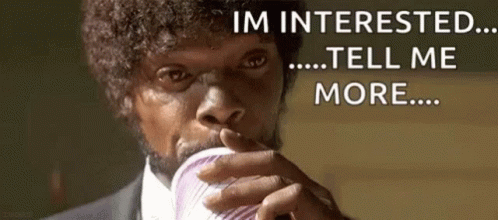 A Man In A Suit Is Drinking From A Cup And Saying `` I 'M Interested ... Tell Me More ... '' GIF