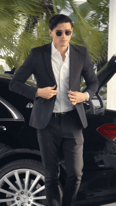 A Man In A Suit Is Getting Out Of A Maybach GIF