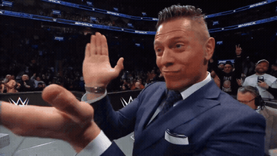 A Man In A Suit Is Giving A High Five In Front Of A Smack Logo GIF