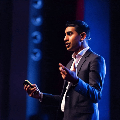 A Man In A Suit Is Giving A Speech With The Words " I Know Blockchain " Behind Him GIF