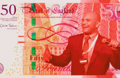 A Man In A Suit Is Giving A Thumbs Up In Front Of A 50 Bank Of England Bill GIF