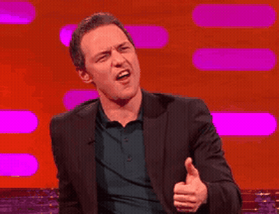 A Man In A Suit Is Giving The Thumbs Up Sign GIF