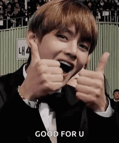 A Man In A Suit Is Giving Two Thumbs Up . GIF