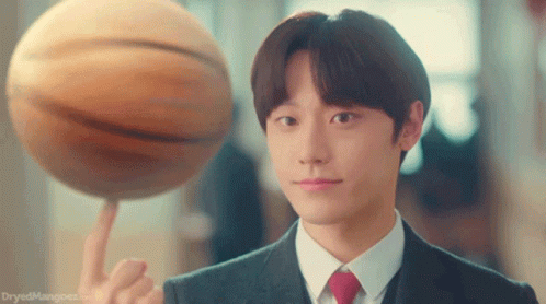 A Man In A Suit Is Holding A Basketball On His Finger GIF