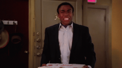 A Man In A Suit Is Holding A Box Of Pizza That Says 2Nd Fresh Pizza On It GIF
